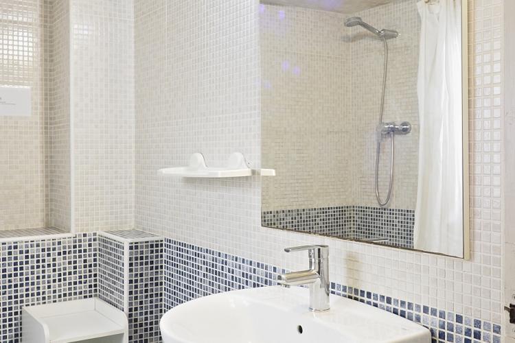 Bathroom is equipped with the shower and has a  small storage for your toiletries