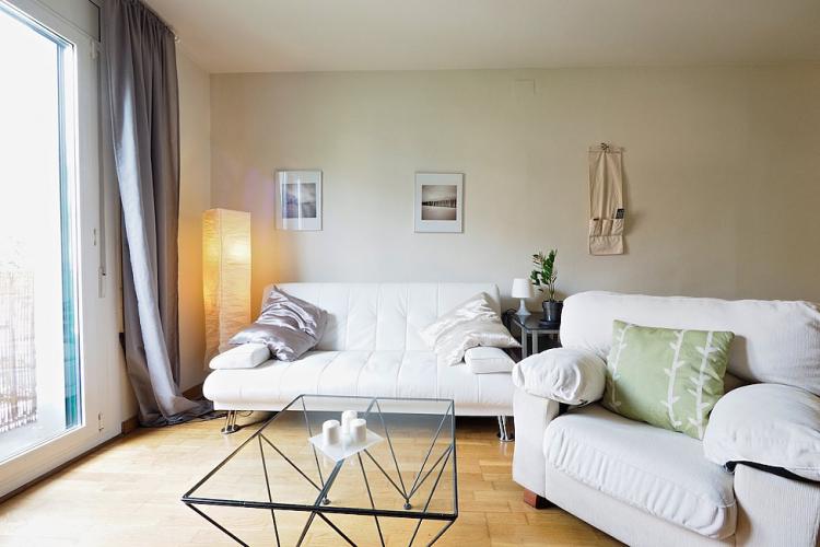 The living room opens to the small balcony, where you can enjoy the lovely view to the neighbourhood