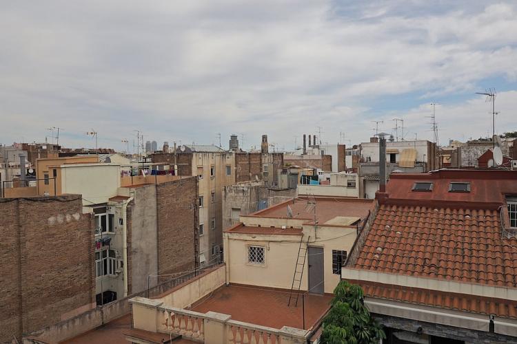 The living room leads to a cozy balcony, overlooking the Poble Sec neighborhood.