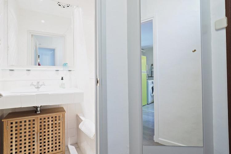 Tasteful wooden bathroom cabinet provides plenty of space to store vanity items.