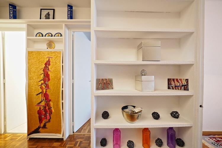 The shelves are decorated with colorful pieces but have plenty of space for your own things.