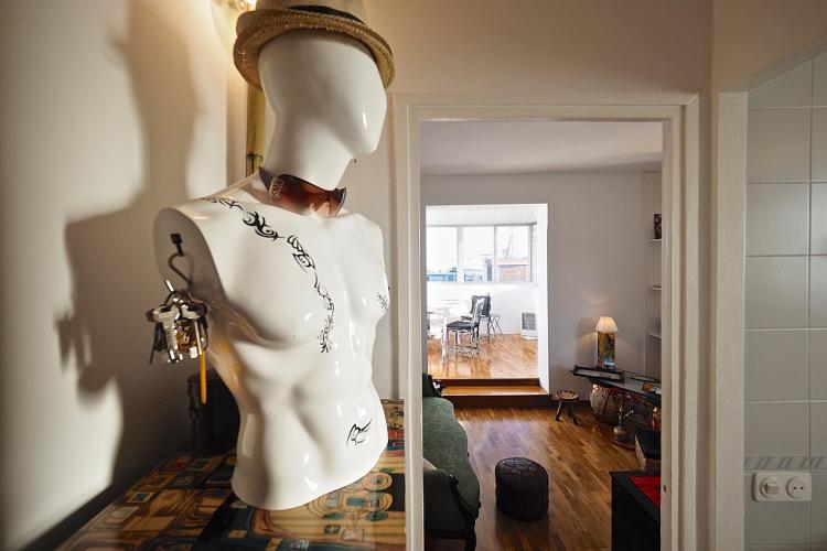 A handsome male mannequin resides silently over the lounge area.