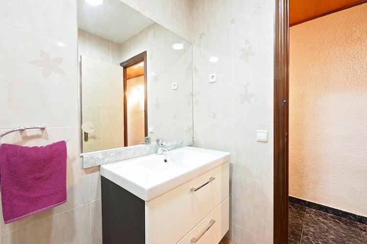 A large mirror and bright lights above the sink makes for a great place to get ready in the morning.