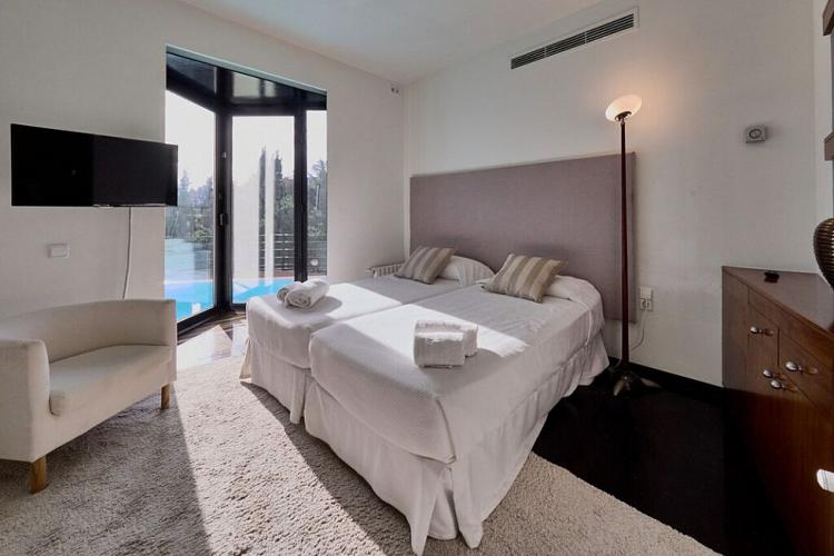 This beautiful bedroom comes carpeted with a warm shag rug and has spectacular views of the pool just across the window.