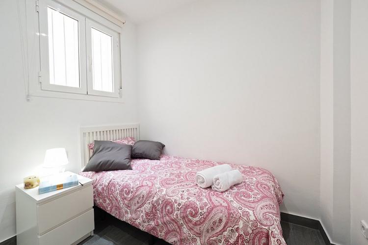 This additional bedroom comes with a nice white nightstand and a comfortable bed to relax on after a day of sightseeing.