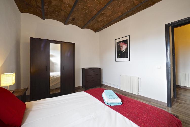 We love the elegant dark wooden furniture in the double bedroom and throughout the apartment.
