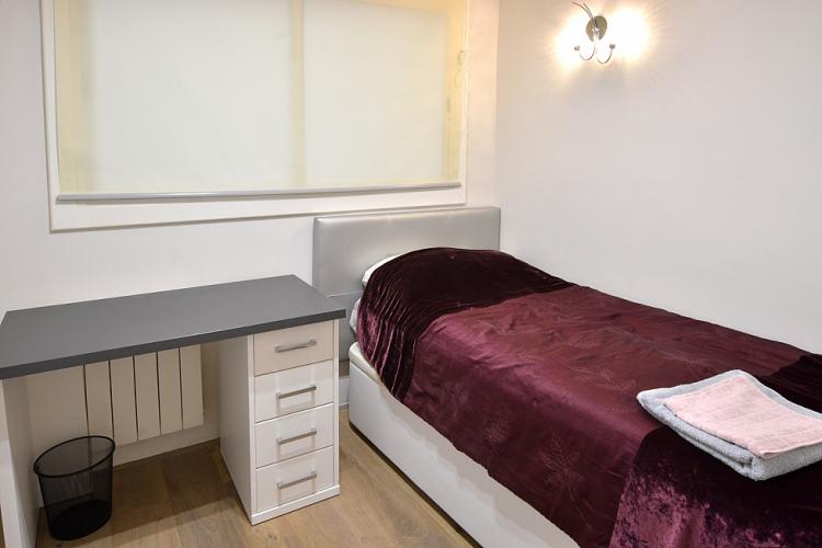One of the smaller single rooms, furnished with a single bed and desk.