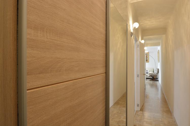 Long hallway with high quality wooden surfaces.