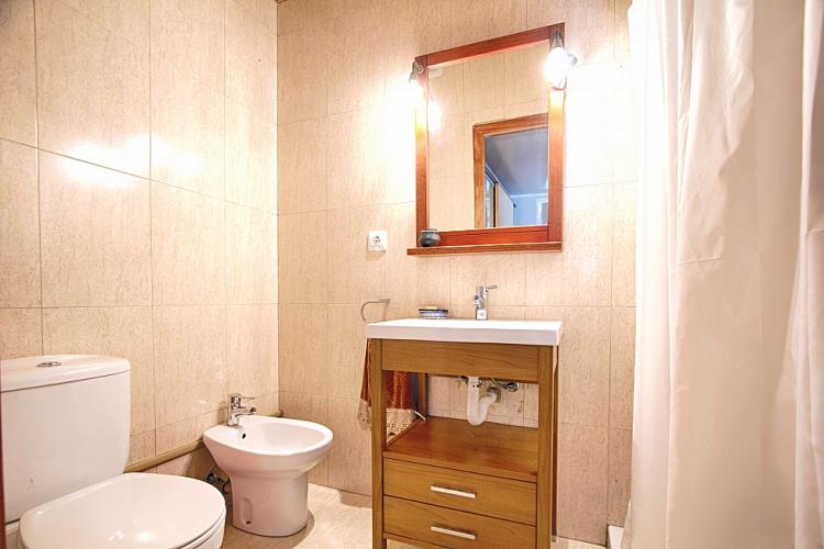 Another bathroom with a bidet and shower.