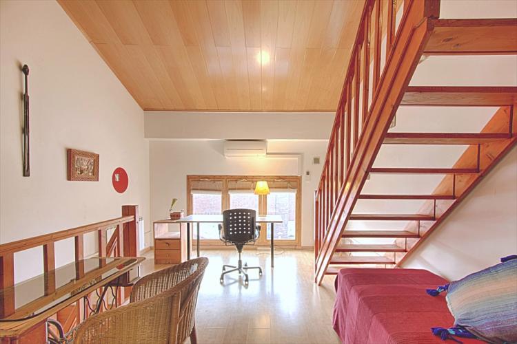 Under the smooth wooden stairs you will find a single bed and a desk perfect for getting some work done.