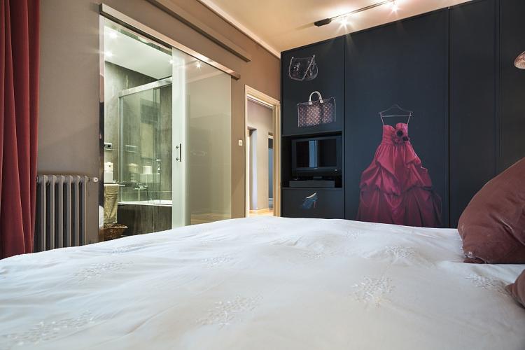 We love the unique murals of jewelry, dresses and gowns adorning the closet of this fabulous bedroom. 
The TV is no longer in this bedroom.