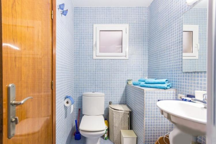 The bathroom is has a refreshing vibe to it with its soft blue mosaic tiles.