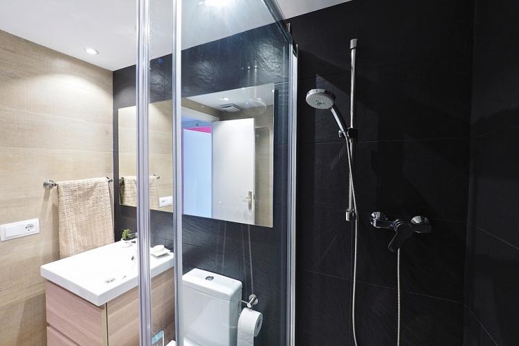The bathroom is equipped with a full shower.