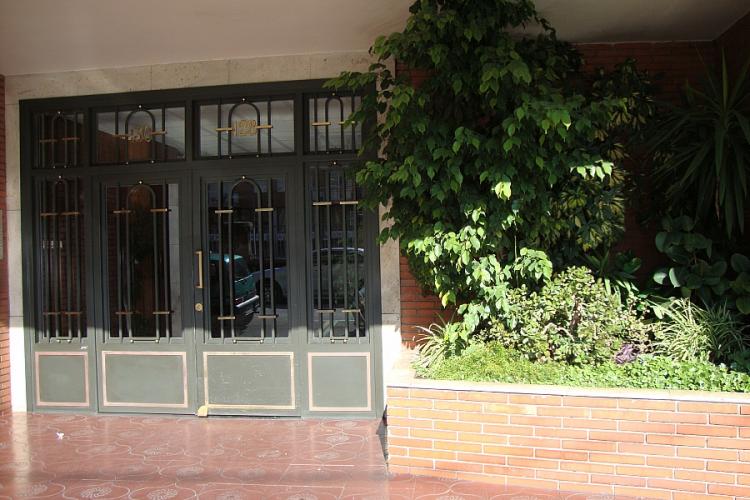 The entrance to the building is secured by iron doors.