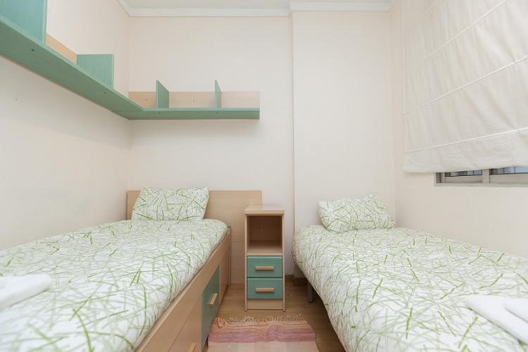 The room comes with comfortable beds and has extra shelves for storage